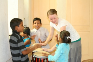 Faith teaching how to play the bongo drums!